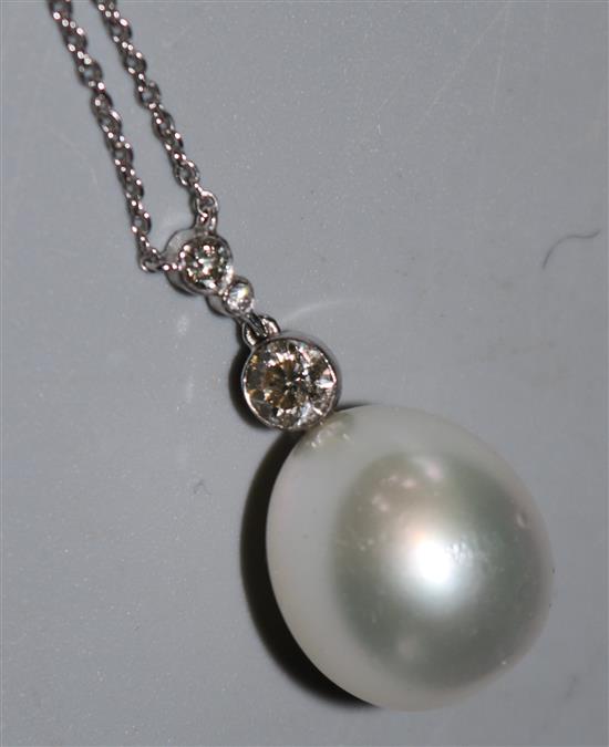An 18ct white gold, diamond and large cultured pearl pendant necklace, 16in.